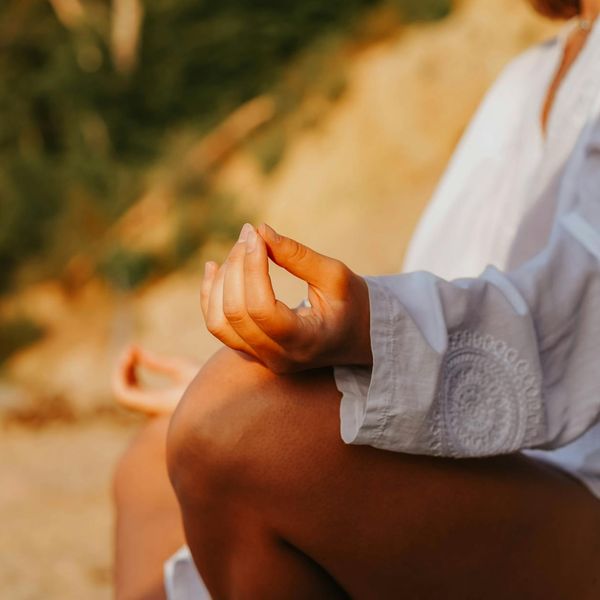 Close-up of a person's hands in a meditative yoga mudra.